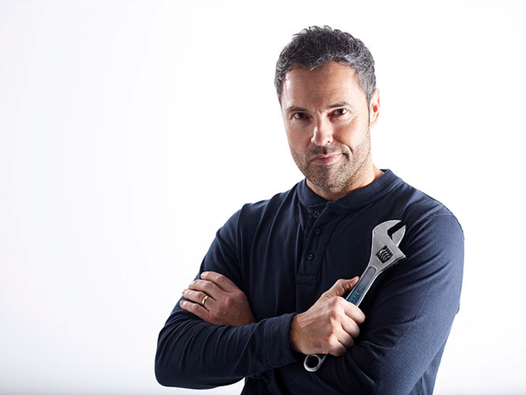 Male model posing with a spanner for a video for Bott Smartvan.