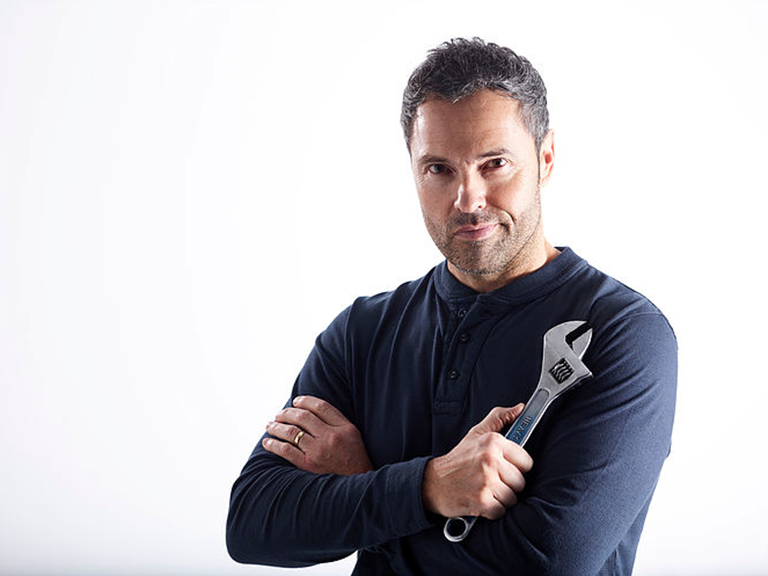 Male model posing with a spanner for a video for Bott Smartvan. 